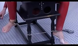Girl in red latex tied up tries to get out