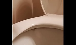 Amateur wife pissing and rubbing clit then licking pee off toilet
