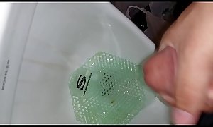 Hard cock cumming in a urinal after a shower